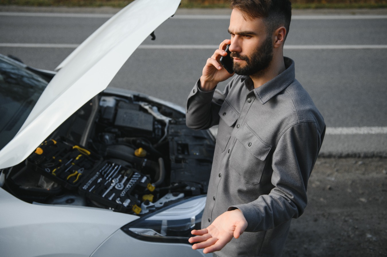 sad-driver-calling-car-service-opening-hood-havi-2025-03-14-22-57-37-utc (2)
