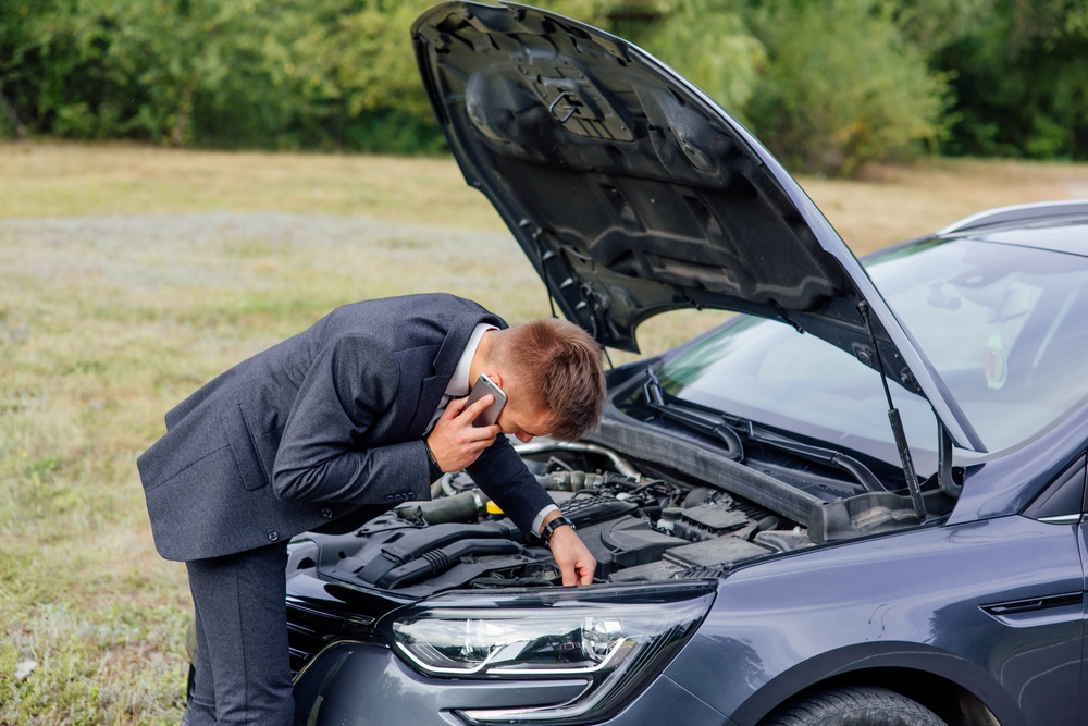 elegant-young-business-man-trying-to-fix-car-break-2024-10-18-09-27-33-utc (1)